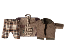 Load image into Gallery viewer, little metal suitcase in the style of a vintage one with destination and hotel stickers. The clotes include a check brown and beige wide tie, Brown tartan check trousers and a brown fleecy jacket.