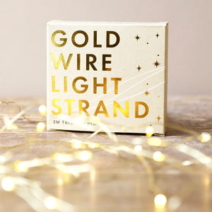 Gold string lights with box packaging in the background