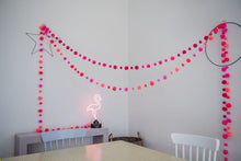 Load image into Gallery viewer, In this picture two garlands have been strung decoratively, diagonally across a room from wall to wall.  There is a table and chairs in the foreground.
