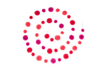 Load image into Gallery viewer, The Pom Pom garland is coiled around, and it can be the seen that the garland has alternating shades of pink and size of pom poms along its length