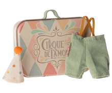 Load image into Gallery viewer, little metal suitcase with harlequin design in pastel colours and the words "Cirque De L'Amour". The tiny clothes are little pale turquoise trousers brown elastic braces and a spotty pointed hat with a little orange pom pom on top.
