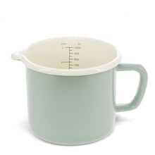 Load image into Gallery viewer, A light sage green enamel mixing jug with a cream-coloured interior, featuring printed measurement markings inside and a sturdy side handle.