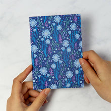 Load image into Gallery viewer, Hand holding a greetings card with a blue floral pattern on a white background
