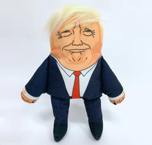 Load image into Gallery viewer, Donald Trump Dog Toy, wearing navy suit with red tie, with recognisable hair style, printed facial features and strangley prange complexion.