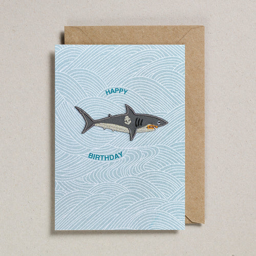 Blue wave printed card with grey embroidered shark patch 
