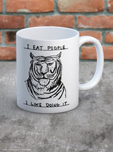Load image into Gallery viewer, David Shrigley Boxed Mug - I Eat People | £10.00. White ceramic mug with David Shrigley line drawing of a tiger with the words "I eat people, I like doing it". The perfect gift for fans of humorous, quirky illustration.