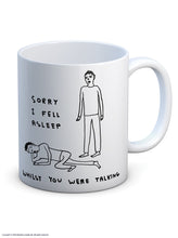 Load image into Gallery viewer, David Shrigley Boxed Mug – Sorry I Fell Asleep | £10.00. White ceramic mug with David Shrigley line drawing of a person asleep at the feet of another with the words “Sorry I fell asleep whilst you were talking”. The perfect gift for fans of humorous, quirky illustration.