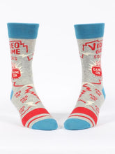 Load image into Gallery viewer, Video Game Men’s crew Socks by Blue Q | £11.95. Ethical and sustainable socks with quirky, humorous designs and vibrant colours. This design features a small man playing videogames on a tv with the words “Video game socks, game on, and on, and on, and on” above. 
