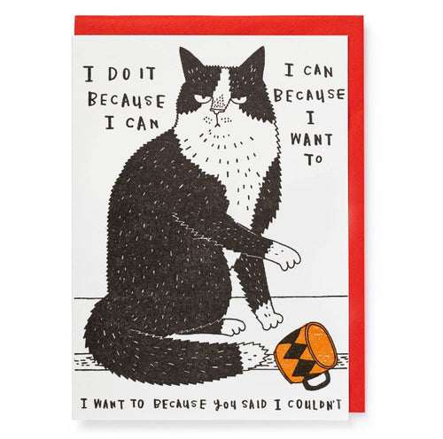 a black and white cat is drawn knocking over a mug.  To the left of the drawing reads 