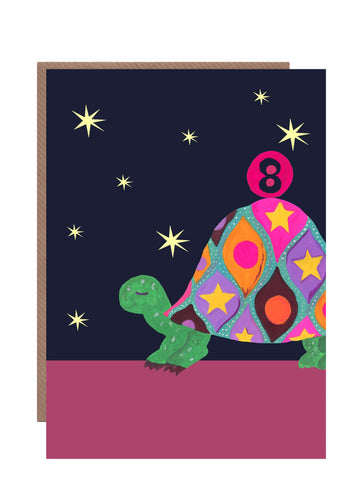 8th birthday card featuring a brightly coloured tortoise balancing a pink ball on its back with the number 8 on it.  The background is black with yellow stars.