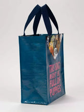 Load image into Gallery viewer, Bag Full of Puppies Lunch Bag Handy Tote by Blue Q | £8.99. Cute little tote bag by blue Q featuring an illustration by John Bond. The bag is mostly dark petrol blue with bright pink lettering which reads “THIS BAG MIGHT BE FULL OF PUPPIES”. At the top edge of the bag 9 little assorted puppies can be seen, as if they are pulling the rim of the bag down and are inside.