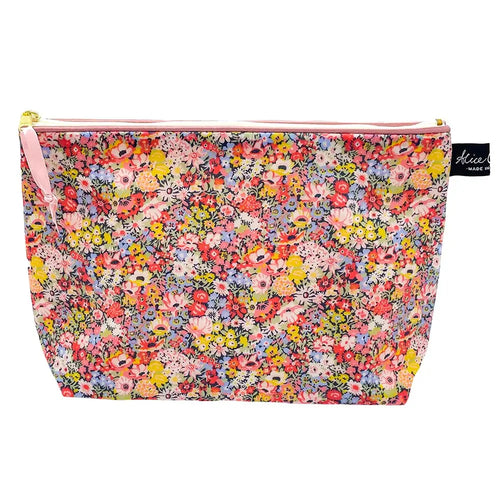  matte pvc wash bag in thorpe hill liberty print. Mini flowers in pale pinks, yellow and red.