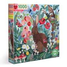 Load image into Gallery viewer, An image of the boxed puzzle.  The brown bunny sits surrounded by poppies and other flowers and mushrooms and a tree with a nesting bird.  A small mouse can also be seen eating a berry. Bbutterflies and bees are flying about.