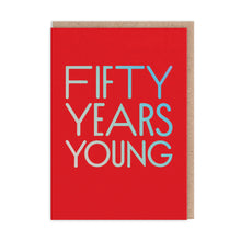 Load image into Gallery viewer, Bright red card with holographic large capital letters “FIFTY YEARS YOUNG”.  The kraft envelope is visible behind
