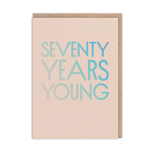 Cream card with large holographic capital lettering “SEVENTY YEARS YOUNG”