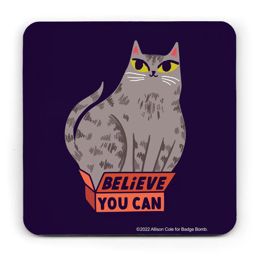 Black background coaster with curved corners.  It has an illustration of a large tabby cat sitting in a small red box, which has the lettering 