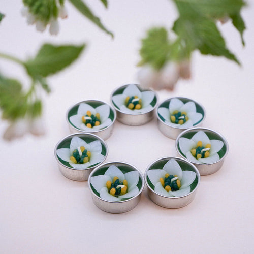 the flower shaped scented tealights out of their packaging, arranged in a circle