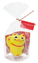 Load image into Gallery viewer, One yellow little lucky cat in cellophane packaging. With a label tied on reading “Flowering Fortune. Grow good luck. Made in Japan”