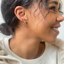 Load image into Gallery viewer, Gold Star Hoop Earrings by Lisa Angel | £18.00. These hoop star-shaped earrings are wonderful for adding a golden finishing touch to your look. Made from 18ct gold plated brass , these earrings open by pulling them gently apart at the top, opening them via the hinge at the bottom to reveal the 18ct gold sterling silver posts.