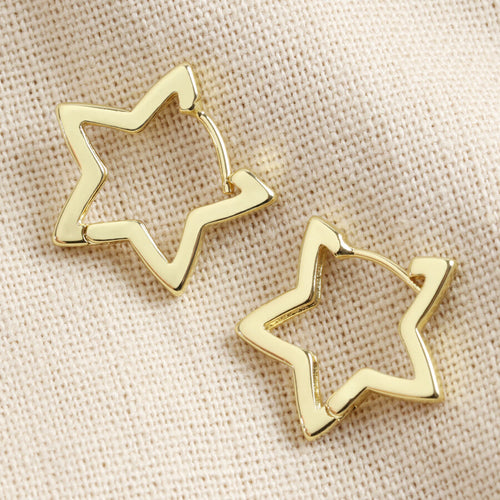 Gold Star Hoop Earrings by Lisa Angel | £18.00. These hoop star-shaped earrings are wonderful for adding a golden finishing touch to your look. Made from 18ct gold plated brass , these earrings open by pulling them gently apart at the top, opening them via the hinge at the bottom to reveal the 18ct gold sterling silver posts.