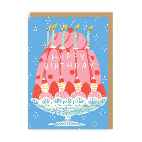 Pink fluted shape birthday  cake. Green dotty candles and blue background with white spots on.  Happy Birthday written  on cake. Illustrated / drawn image