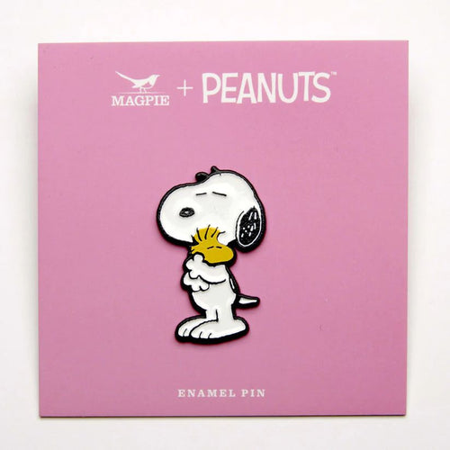 The pin comes on a pink design backing card.