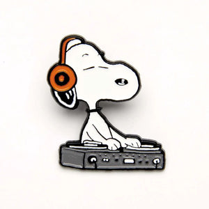 The pin is of snoopy with headphones mixing music