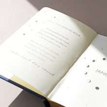Load image into Gallery viewer, Navy Five Year Thought a Day Journal by Lisa Angel | £12.00. This adorable pocket-sized journal is covered in navy fabric and adorned with gold foil details on the front cover. Featuring a moon phase emblem on the front of the book, the pretty gold details perfectly match the glittering golden page edges. 
