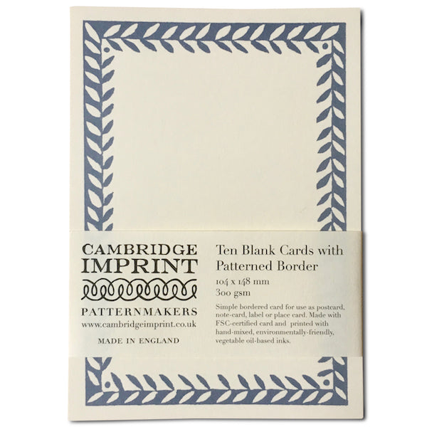 Pack of 10 postcards plain with cornflower blue leaflike patterned border. A wrap  around paper label holds them together, printed with Cambridge Imprint’s logo and product information.