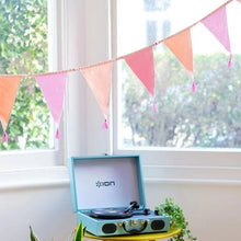 Load image into Gallery viewer, the bunting is seen hanging indoors with a window and record player in the background
