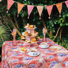 Load image into Gallery viewer, the bunting can be seen hanging accross a table laden with cakes in a leafy garden.
