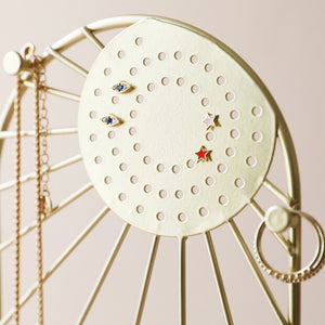 Sunshine Jewellery Stand by Lisa Angel | £22.00. The arched frame is made of gold metal and features a beaming sun design complete with cloud detailing. On the round sun face are holes for studs and hook earrings, while the edge of the frame has pegs made for your necklaces and longer pieces. The base of this stand is made of terrazzo resin in speckled whites, creams and greys to finish this sweet jewellery storage piece. 