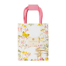Load image into Gallery viewer, A pack og 8 fairy illustrated paper treat bags.  the bags are white with delicate illustrations of flowers and butterflies in yellow, pink and blue.  A fairy is sitting on a mushroom
