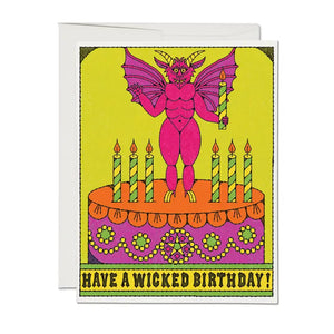 Have a Wicked Birthday card by red cap cards, illustrated by Nolan Pelletier, featuring a brightly coloured demon on top of a birthday cake.  Neon pink, orange and yellow