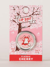 Load image into Gallery viewer, Classic Cherry Lip S**t by Blue Q | £7.50. All natural, vitamin E fortified lip balm. The lip balm is contained within a round metal tin with a sticker on the front depicting sweet fox meditating with the words “Lip Shit”.
