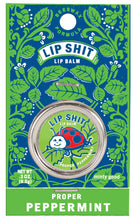 Load image into Gallery viewer, Proper Peppermint Lip S**t by Blue Q | £7.50. All natural, vitamin E fortified lip balm. The lip balm is contained within a round metal tin with a sticker on the front depicting a ladybird smiling with the words “Lip Shit” above.
