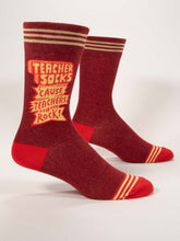 Load image into Gallery viewer, Teachers Rock Socks Men’s crew Socks by Blue Q | £11.95. Ethical and sustainable socks with quirky, humorous designs and vibrant colours.  This design is in red with the words “Teacher Socks, ‘cause teachers rock!” in comic-style writing”. Perfect gift for teachers. 
