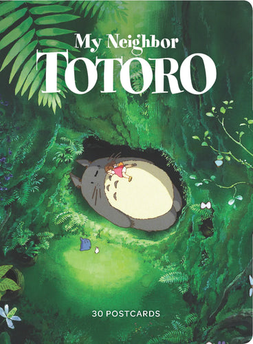 Cover photo of box of 30 My Neighbour Totoro postcards.  Totoro is seen lying in the lush green forest with small girl sleeping on his chest