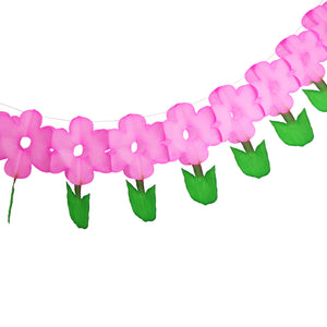 paper honeycomb garland of connected pink simple daisy like flowers with green stems and leaves