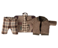 Load image into Gallery viewer, little metal suitcase in the style of a vintage one with destination and hotel stickers. The clotes include a check brown and beige wide tie, Brown tartan check trousers and a brown fleecy jacket.
