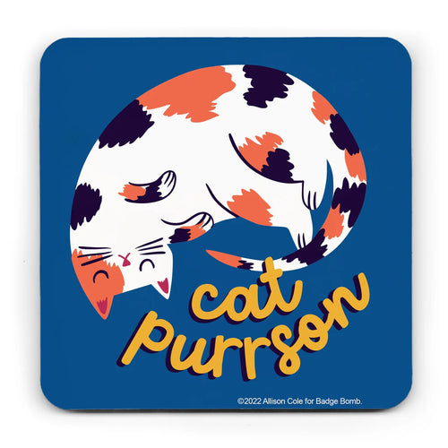 This coaster has a blue background and curved off edges.  It has an illustration of a tortoisehll curled up sleeping cat with the words 