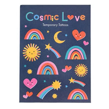 Load image into Gallery viewer, A sheet of temporary tattoos featuring cute cosmic and love-themed designs, including rainbows, smiling suns, stars, hearts, and a crescent moon on a dark navy blue background. The top of the sheet reads 'Cosmic Love Temporary Tattoos' in colorful lettering.
