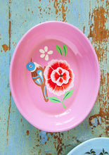 Load image into Gallery viewer, Pink enamel shallow bowl with a bright floral/ bird design on a rustic wooden surface
