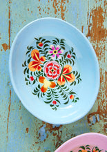 Load image into Gallery viewer, Decorative light blue enamel oval vowl with a bright floral design on a rustic wooden surface
