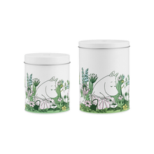 Load image into Gallery viewer, Two white tins with illustrations of Moominmama busy in a garden on a white background
