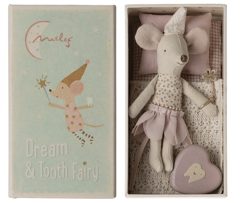 Maileg's tooth fairy, wearing a little  soft pointed cap and holding a sparkly wand.  She is wearing a layered  pink petal shaped skirt and has a fixed spotty top.  She has a gingham covered mattress and beautiful crochet look soft cream blanket.  Inside the box is also a little enamel heart shape tin with a smiling tooth on it.  The top of the box  has an illustration of a tooth fairy mouse holding her wand and carrying a tooth.  Below are the words 
