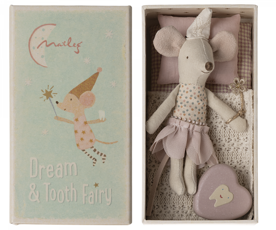 Maileg's tooth fairy, wearing a little  soft pointed cap and holding a sparkly wand.  She is wearing a layered  pink petal shaped skirt and has a fixed spotty top.  She has a gingham covered mattress and beautiful crochet look soft cream blanket.  Inside the box is also a little enamel heart shape tin with a smiling tooth on it.  The top of the box  has an illustration of a tooth fairy mouse holding her wand and carrying a tooth.  Below are the words 