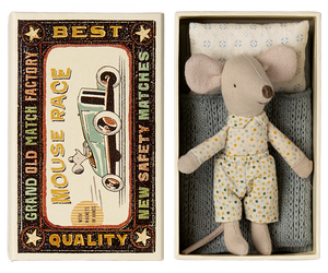 Maileg toy mouse in matchbox styled box.  The box has an illustratiion remeniscent of an old matchbox with a picture of a mouse driving an old open car.  Around the edges as the words "Grand Old Match Factory, New SAfety Matches".  The mouse inside has a soft blue striped mattress an a soft blue knitted blanket.  He is wearing a fixed spotty shirt with little collars and some matching spotty trousers.  HEe also has a sweet delicatley patterned pillo, cream with a blue repeating pattern.