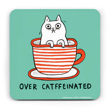 Load image into Gallery viewer, Light blue coaster illustrated with a comical tired-looking cat sitting in a red and white stripey cup and saucer. Underneth are the words &#39;over catffeinated&#39;
