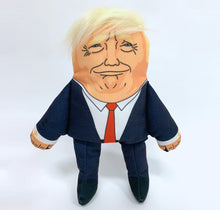 Load image into Gallery viewer, Donald Trump Dog Toy, wearing navy suit with red tie, with recognisable hair style, printed facial features and strangley prange complexion.

